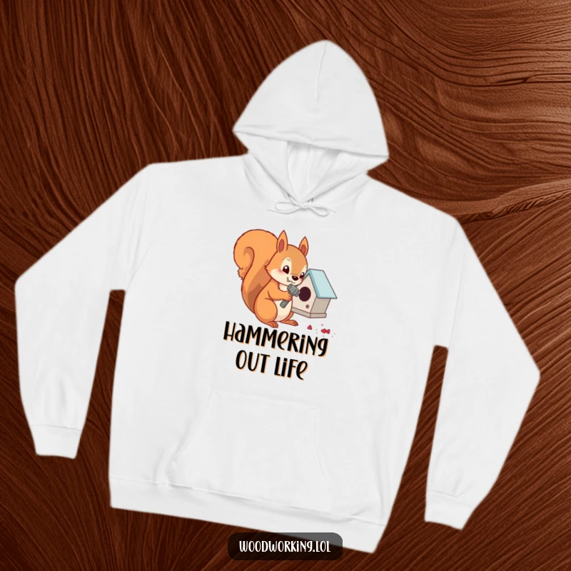 Funny determined squirrel hammering nails into a tiny birdhouse, perfect for a warm hoodie.