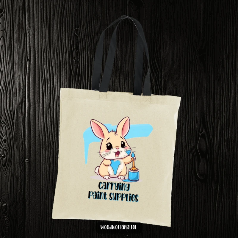 Funny rabbit tote bag showing a surprised bunny covered in blue paint, perfect for carrying art supplies with humor.